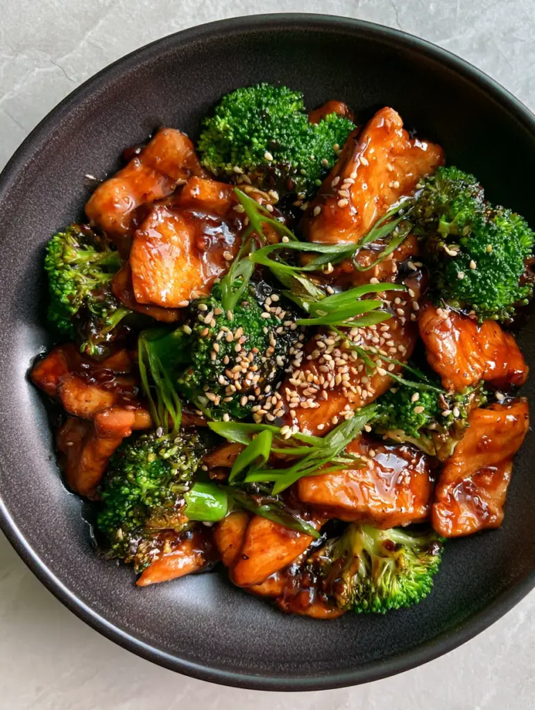 Chicken and Broccoli with a Glossy Garlic Soy Glaze 1 Top-down shot of tender-crisp emerald broccoli and chicken in a thick soy glaze. (chicken and broccoli)