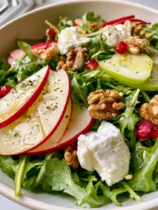 Extreme macro close-up of vibrant Apple Arugula Salad showing translucent apple slices and glistening baby arugula leaves.